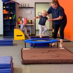 coach and boy on trampoline